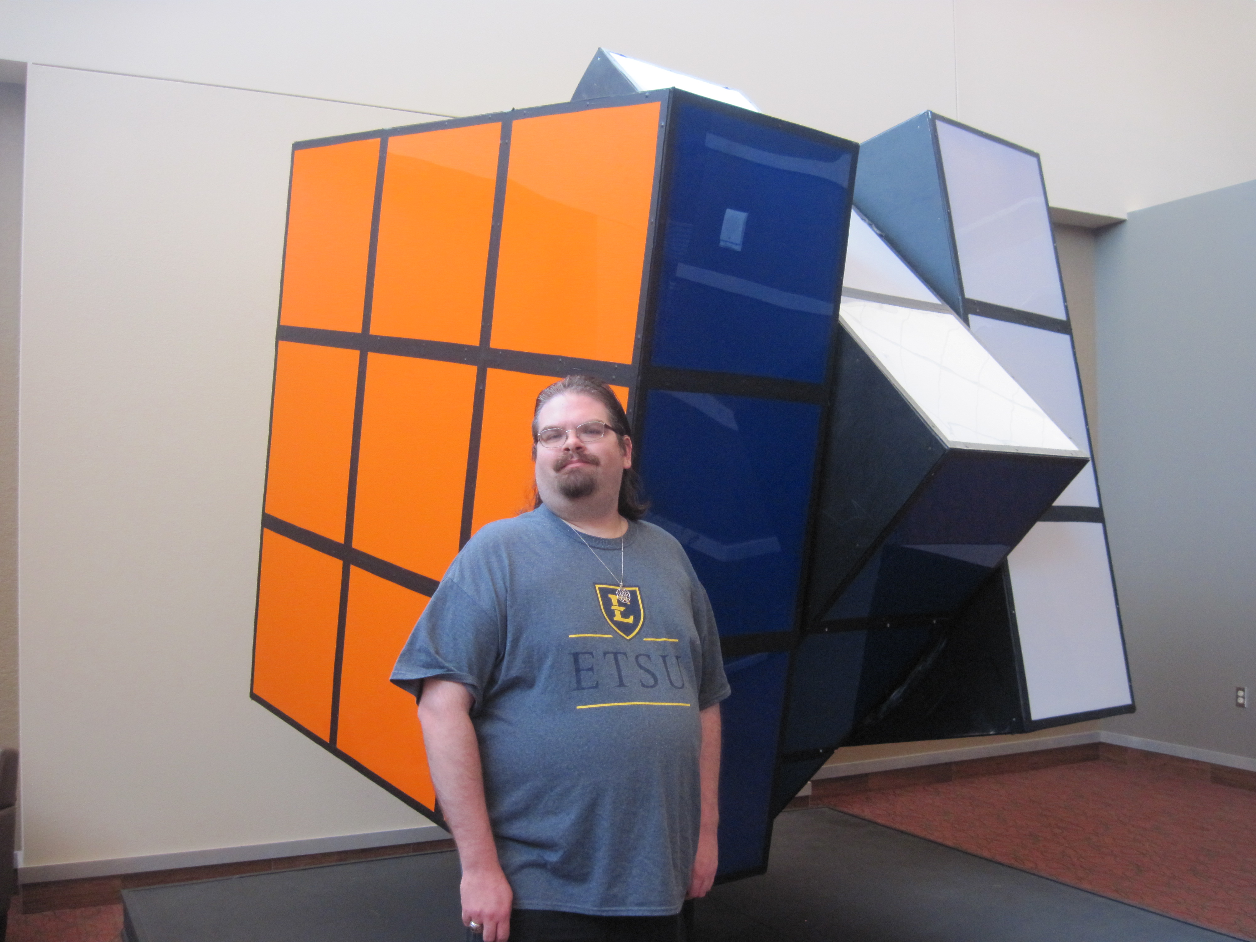Dr. Beeler next to the Rubik's Cube Exhibit from the 1982 World's Fair